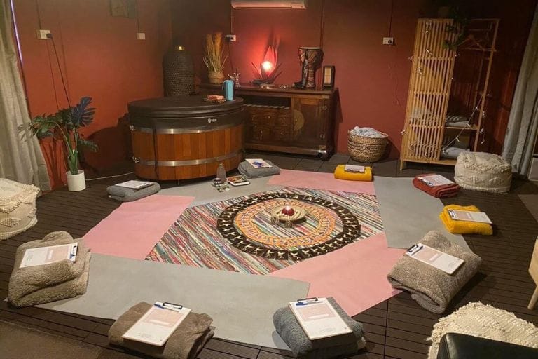 A beautifully arranged ceremony space at Eltham Wellness Centre, featuring a central mandala, meditation cushions, and a warm, inviting ambiance. The setup is designed for workshops, guided sessions, and group gatherings.
